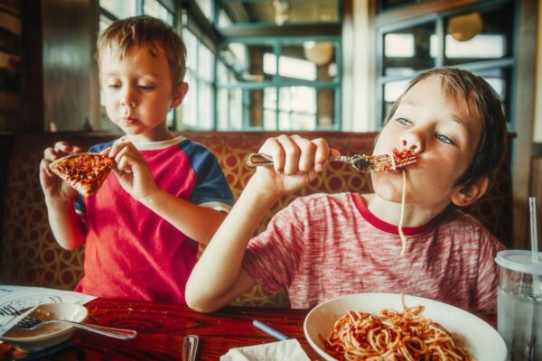 Kids eating pizza and pasta